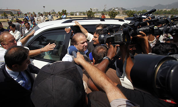 Pakistan's incoming prime minister, Nawaz Sharif, center, gets surrounded by media as he arrives to attend the first National Assembly session in Islamabad, Pakistan, Saturday, June 1, 2013. (AP/Anjum Naveed)