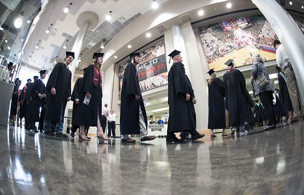 Graduates enter Mississippi State University's Humphrey Coliseum on Saturday, May 11, 2013. Sequestration is making it difficult for many students, particularly those from low-income families, to afford a college education in the United States. (AP Photo/MSU/Megan Bean)