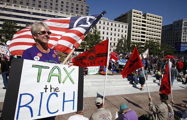 Carol Gay, of Brick, New Jersey, holds a sign saying