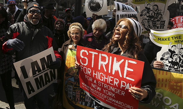 Demonstrators hold signs and chant slogans outside of a Wendy's restaurant, Thursday, April 4, 2013, in New York. (AP/Mary Altaffer)