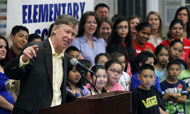 Colorado Gov. John Hickenlooper (D) speaks to a gathering of primary school students, teachers, and administrators at Rose Hill Elementary, in Commerce City, Colorado, Wednesday, May 15, 2013. (AP/Brennan Linsley)