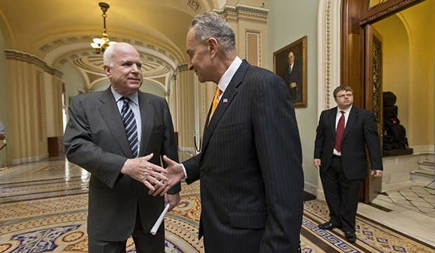 Sen. John McCain (R-AZ), left, and Sen. Charles Schumer (D-NY), right, two of the authors of the immigration reform bill crafted by the Senate's bipartisan 