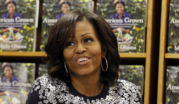 First Lady Michelle Obama signs copies of her book <i>American Grown: The Story of the White House Kitchen Garden and Gardens Across America</i> at the Politics & Prose bookstore in Washington, Tuesday, May 7, 2013. (AP/Susan Walsh)