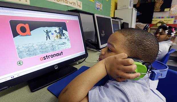 In this Friday, March 1, 2013, photo, J'son Hayes works on a computer in his prekindergarten class at a public school in Buffalo, New York. (AP/David Duprey)