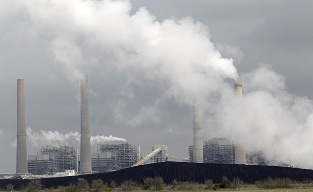 In this Wednesday, March 16, 2011, file photo, exhaust rises from smokestacks in front of piles of coal at NRG Energy's W.A. Parish Electric Generating Station in Thompsons, Texas. (AP/David J. Phillip)