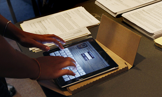 A student unpacks a new iPad at Burlington High School in Burlington, Massachusetts. (AP/Elise Amendola)