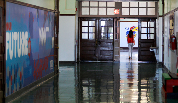 A student walks down a hallway at the Jean de Lafayette Elementary School on the final day of school, Wednesday, June 19, 2013, in Chicago. (AP/Scott Eisen)