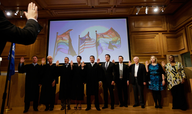 City officials performing same-sex marriages are sworn in before conducting wedding ceremonies in West Hollywood, California, Monday, July 1, 2013. (AP/Jae C. Hong)