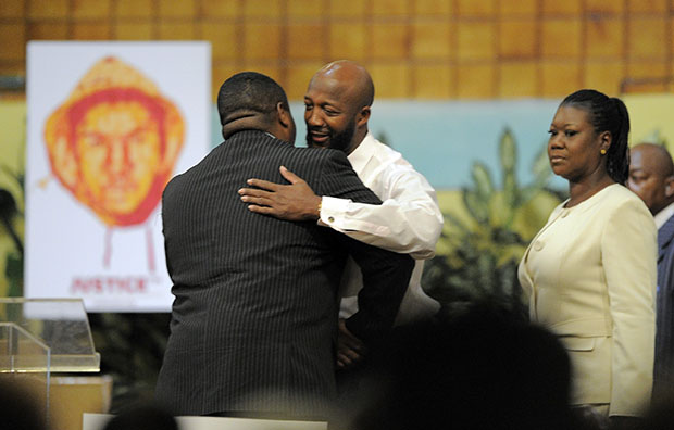 Pastor Charles Blake lll, left, greets Tracy Martin, center, and Sybrina Fulton, the parents of shooting victim Trayvon Martin, during a rally on behalf of Trayvon's family, Thursday, April 26, 2012, in Los Angeles, California. (AP/Mark J. Terrill)