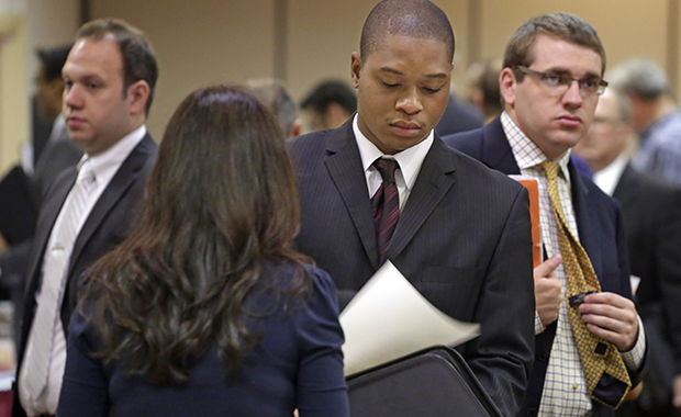 Job seekers wait to speak with Patrice Tosi of BluePay, second from left, during a career fair in Rolling Meadows, Illinois. (AP/M. Spencer Green)