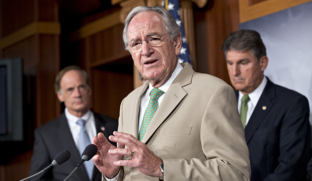 Sen. Tom Harkin (D-IA), chairman of the Senate Health, Education, Labor and Pensions Committee, announces to reporters that a bipartisan agreement was reached on lowering rates for government student loans, at the Capitol in Washington, Thursday, July 18, 2013. At left is Sen. Tom Carper (D-DE), with Sen. Joe Manchin (D-WV) at right. (AP/J. Scott Applewhite)
