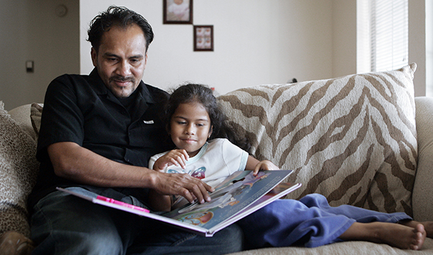Jonadad Luque reads to his daughter, Jarlin, 5, in their home in Nashville, Tennessee. (AP/Mark Humphrey)