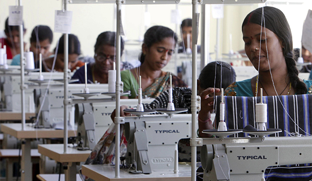 Indian workers sew at a garment factory on the outskirts of Hyderabad, India, Friday, October 12, 2012. (AP/Mahesh Kumar A.)