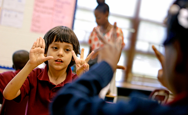 In this Thursday, April 18, 2013 photo, Burgess-Peterson Elementary School second grader Dion Yantiri, left, works through a math problem as part of Atlanta Public Schools' afterschool remediation program in Atlanta, Georgia. (AP/David Goldman)