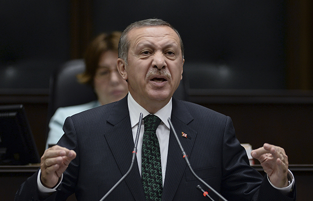 Turkey's Prime Minister Recep Tayyip Erdoğan addresses lawmakers and supporters of his ruling Justice and Development Party at the parliament in Ankara, Turkey, Tuesday, June 11, 2013. (AP)