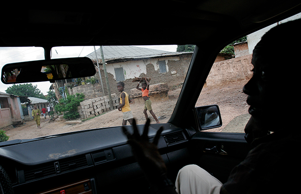 An undercover officer working on drug-related cases for the judicial police speaks with journalists in a car in Bissau, Guinea-Bissau, July 16, 2007. (AP/Rebecca Blackwell)