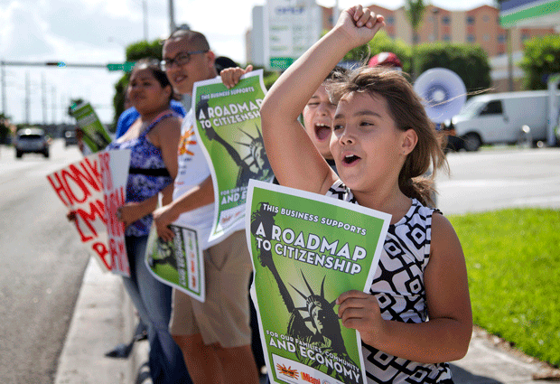 Immigration activists rally in Miami, Florida, to ask the House of Representatives to approve immigration reform that includes a path to citizenship. (AP/J Pat Carter)