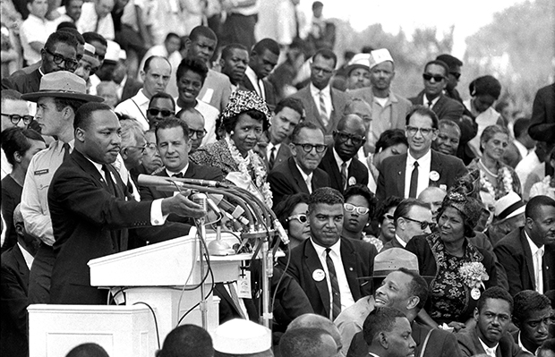 Dr. Martin Luther King Jr., head of the Southern Christian Leadership Conference, speaks to thousands of people during his