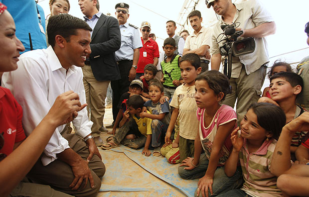 Rajiv Shah, second from left, the head of the U.S. Agency for International Development, or USAID, speaks to Syrian refugee children in one of the UNICEF tents at Zaatari Refugee Camp in Mafraq, Jordan, September 5, 2012. (AP/Mohammad Hannon)