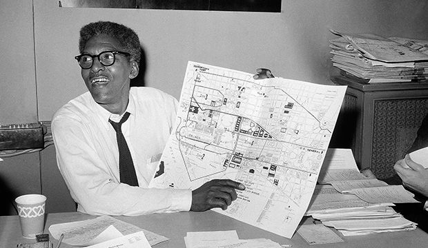 In this August 24, 1963, file photo, Bayard Rustin points to a map showing the path of the March on Washington during a news conference at the New York City headquarters. (AP)
