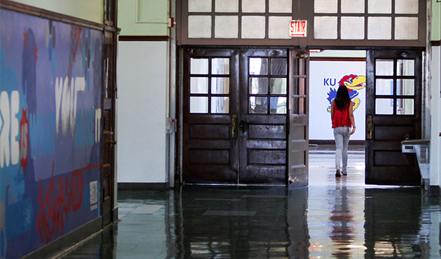 A lone student walks down a hallway at the Jean de Lafayette Elementary School, on the final day of school, Wednesday, June 19, 2013, in Chicago. (AP/Scott Eisen)