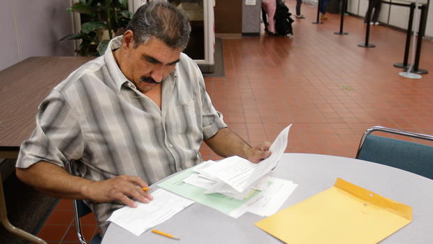 Luis Rodriguez, who has been out of work for a year, fills out some forms at the California Employment Development Department office in Sacramento, California, Friday, September 20, 2013. (AP/Rich Pedroncelli)