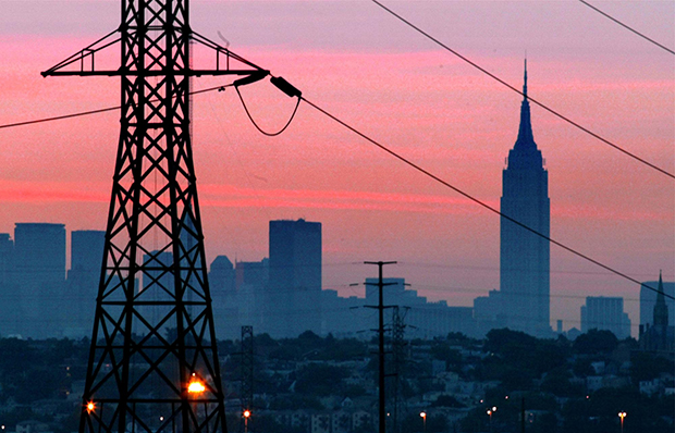 A darkened New York City is visible just before dawn through power lines from Jersey City, New Jersey, August 15, 2003. The Empire State Building is in the background. (AP/George Widman)