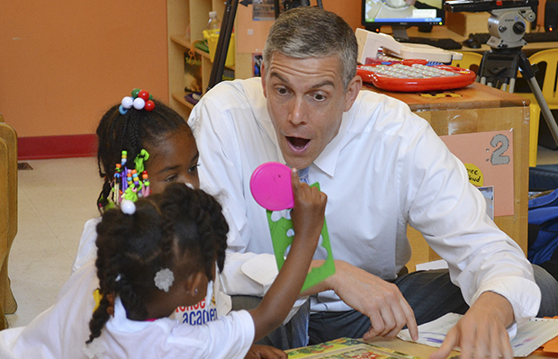 U.S. Secretary of Education Arne Duncan visits with young students at the St. Benedict Center for Early Childhood Education in Louisville, Kentucky, Thursday, June 20, 2013. (AP/Dylan Lovan)