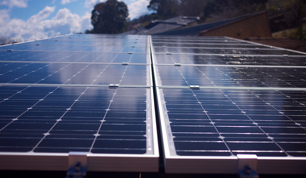 Solar panels are affixed to a roof. (flickr/Michael Mazengarb)