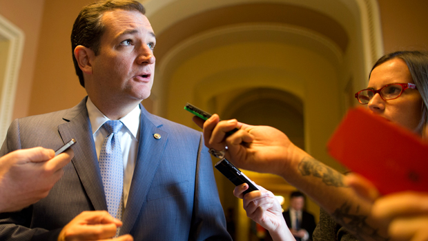 Sen. Ted Cruz (R-TX) talks with reporters as he walks to the Senate floor on Capitol Hill, Saturday, October 12, 2013. (AP/ Evan Vucci)