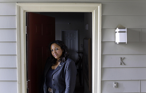 Felicia Evans Long, a program analyst at the National Institutes of Health who is currently furloughed due to the partial federal government shutdown, stands outside her home in Rockville, Maryland, Thursday, October 3, 2013. (AP/Patrick Semansky)