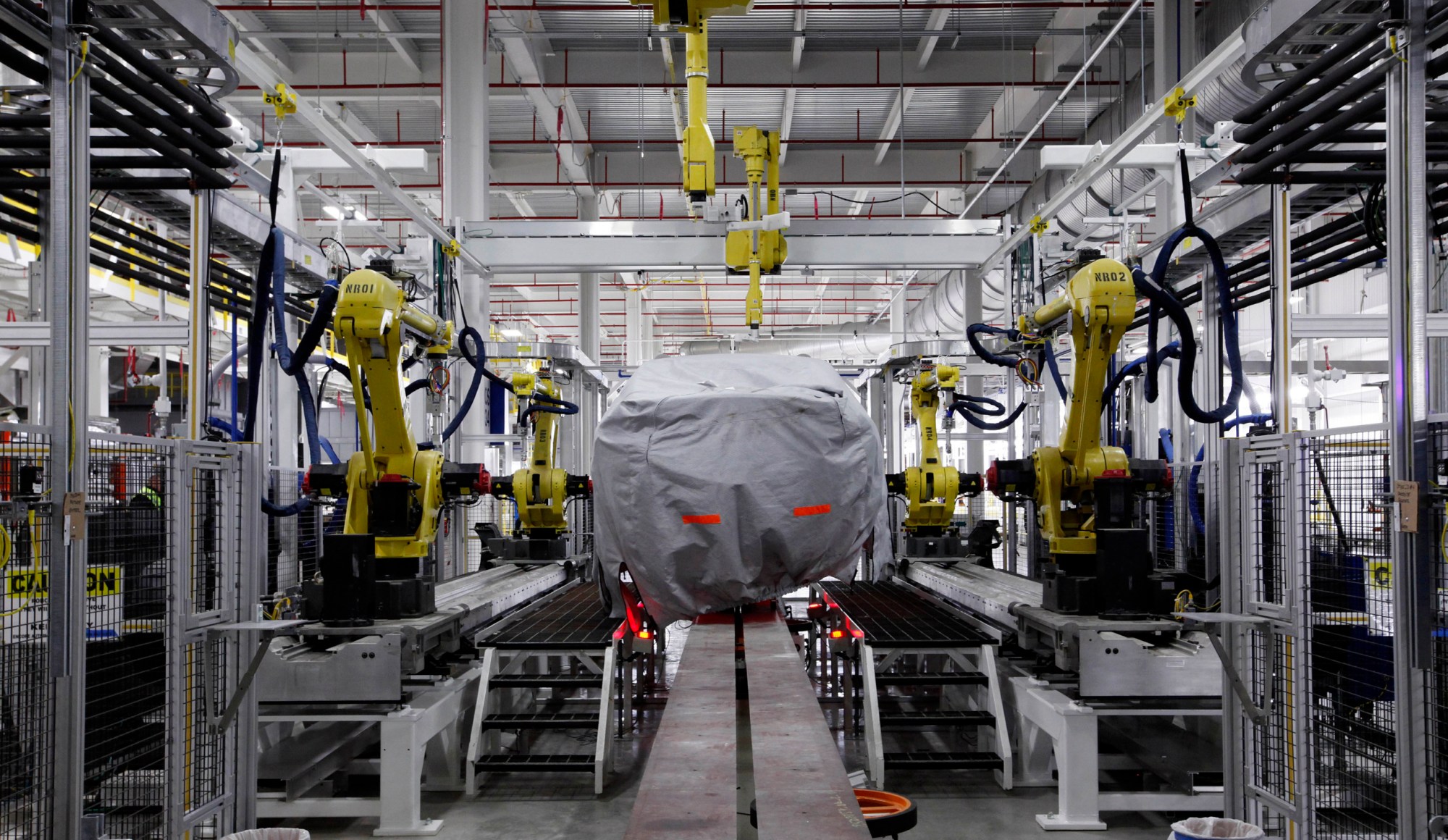 A covered vehicle sits in the new paint shop at Chrysler's Sterling Heights Assembly Plant in Sterling Heights, Michigan. (AP/Paul Sancya)