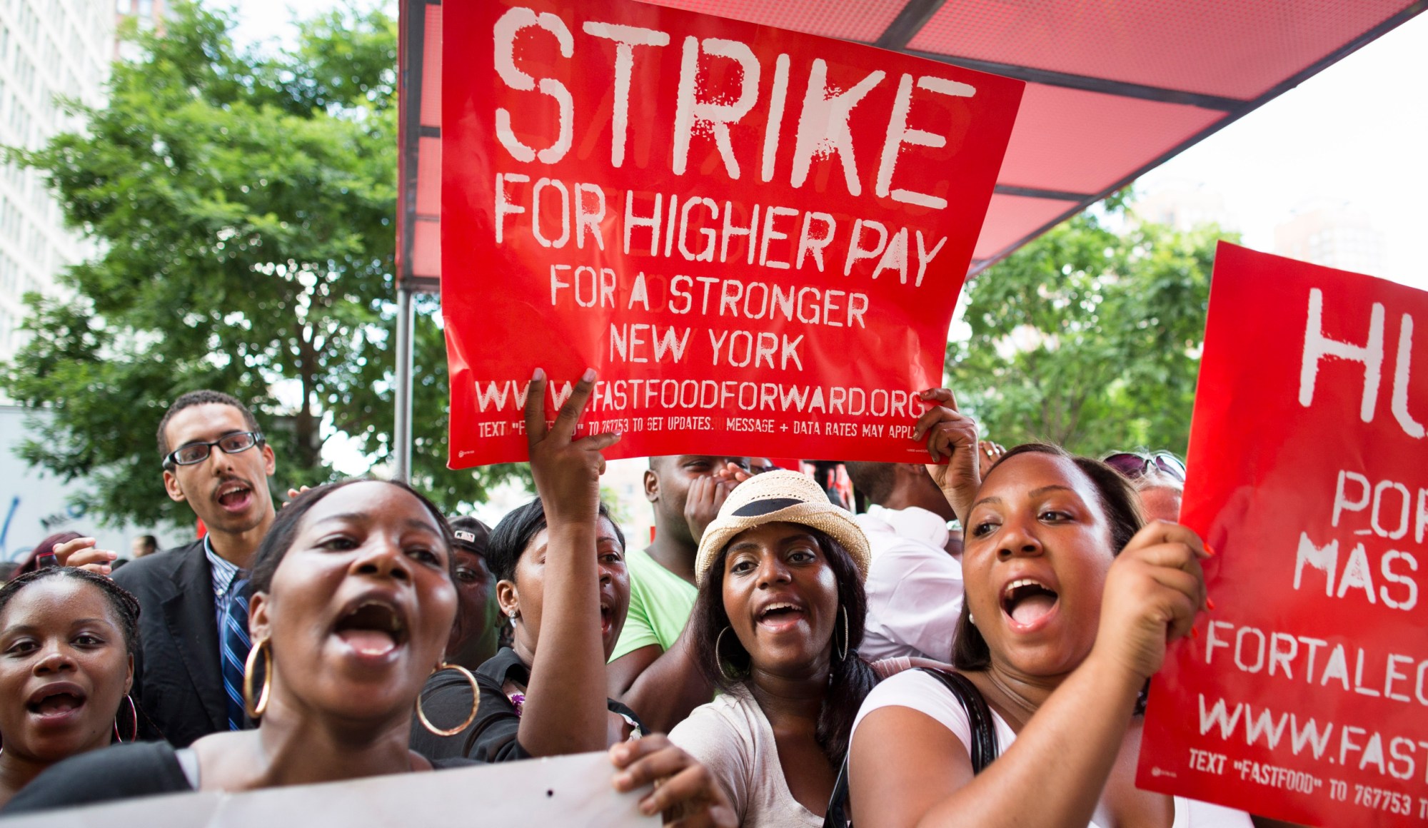 Demonstrators outside a McDonald's in New York City's Union Square show their support for hundreds of striking fast-food workers across the county in July. The workers were demanding higher wages, better benefits, and the right to form a union without retaliation. (AP/John Minchillo)