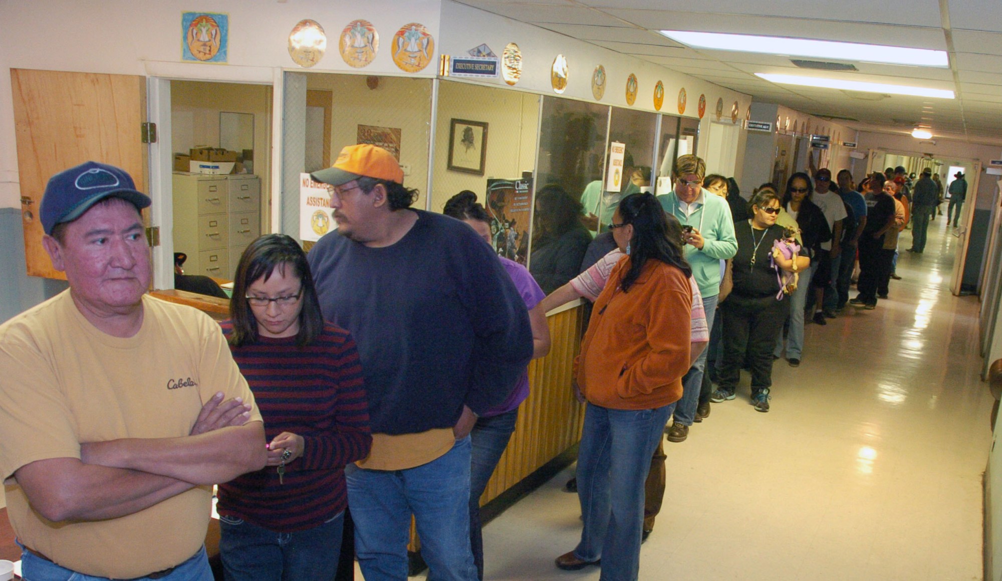 Crow Tribe employees line up to receive their paychecks. These are some of more than 300 tribal employees who were furloughed during the federal government shutdown. (AP/Matt Brown)