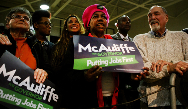 Ernestine Byrd, center, reacts while listening to a speech by Governor-elect Terry McAuliffe during a rally, Sunday, October 27, 2013, in Hampton, Virginia. (AP/Jason Hirschfeld)