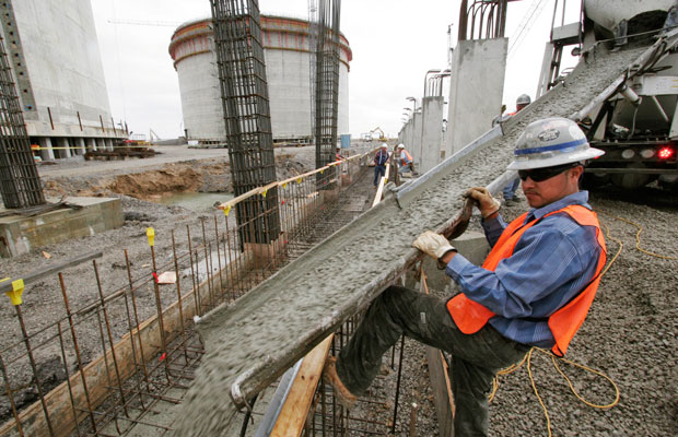 Salvador Pantoja directs the flowing concrete at the Sempra liquefied natural gas plant under construction in Hackberry, Louisiana, April 4, 2007. (AP/Alex Brandon)