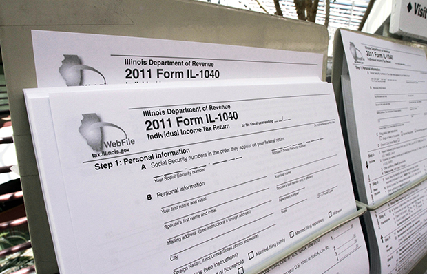 A 2011 1040 tax form is seen with other tax forms at the entrance of the Illinois Department of Revenue in Springfield, Illinois. (AP/Seth Perlman)