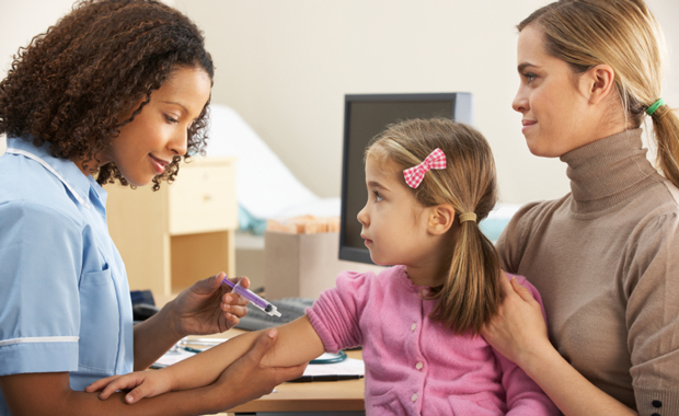 A young girl receives a vaccine. (iStockphoto/Mark Bowden)