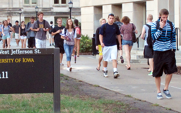 In this 2012 photo, students walk between classes on campus at the University of Iowa in Iowa City, Iowa. (AP/Ryan J. Foley)