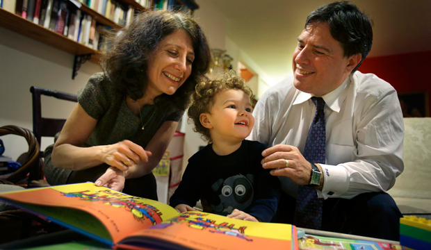 Drew and Frances Pardus-Abbadessa play with their son Pavol, 1, at their apartment in New York on January 30, 2013. (AP/Seth Wenig)