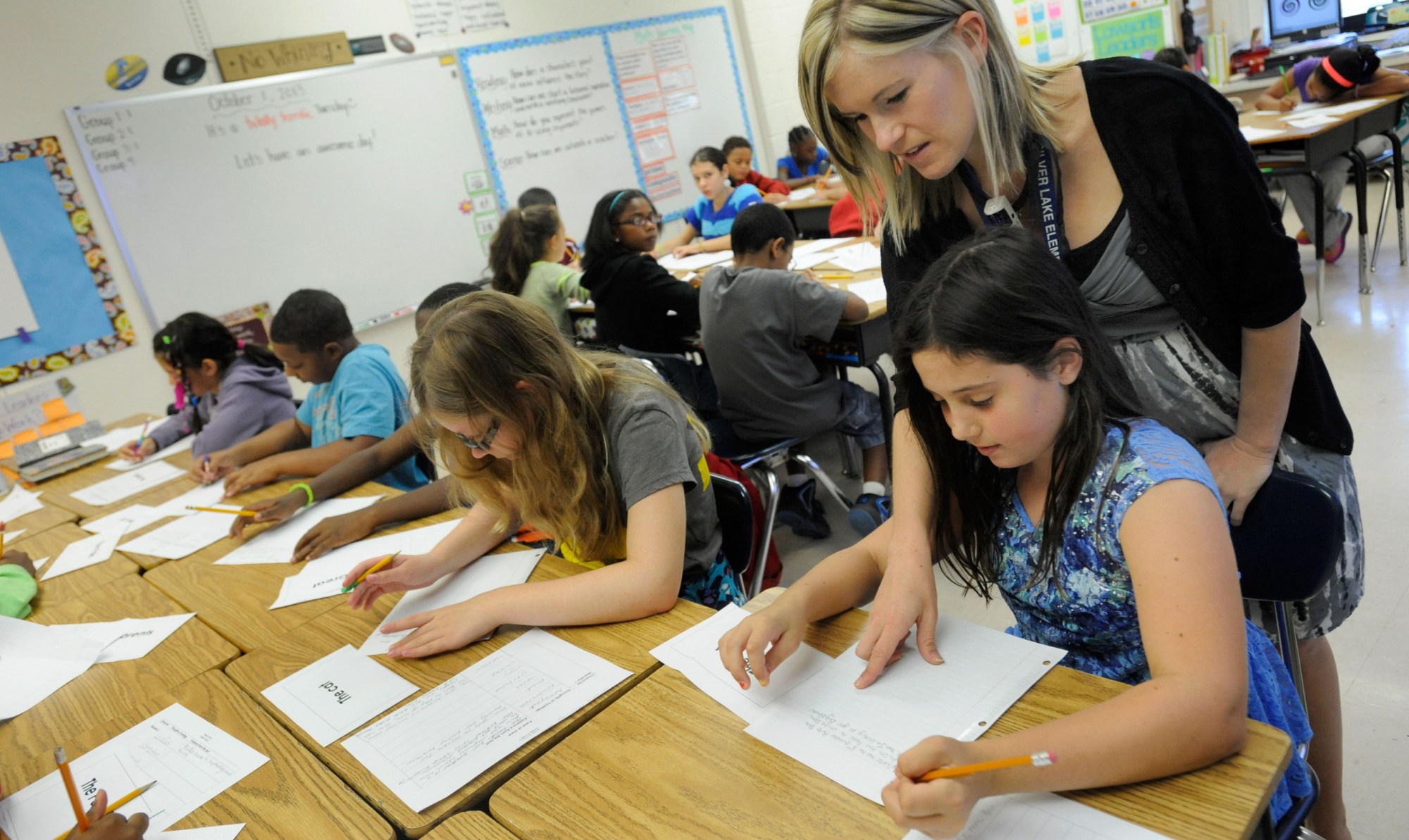 Amy Lawson, a fifth-grade teacher at Silver Lake Elementary School in Middletown, Delaware, helps student Melody Fritz with a language arts lesson. (AP/Steve Ruark)