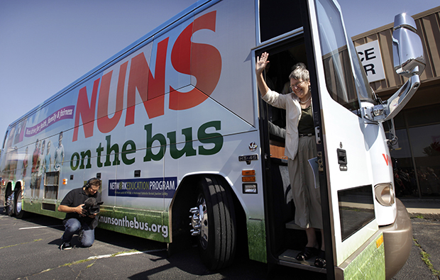 Sister Simone Campbell, executive director of NETWORK, waves as she steps off the bus during a stop on the first day of a nine-state Nuns on the Bus tour, Monday, June 18, 2012, in Ames, Iowa. (AP/Charlie Neibergall)