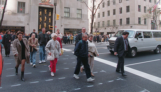 Pedestrians cross Fifth Avenue in the middle of the block between 49th and 50th streets in Manhattan. (AP/Ed Bailey)