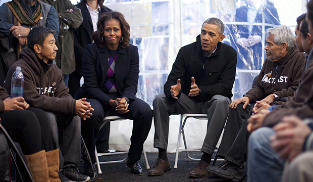 President Barack Obama and First Lady Michelle Obama visit with individuals who are taking part in Fast for Families on the National Mall in Washington, Friday, November 29, 2013. (AP/Pablo Martinez Monsivais)