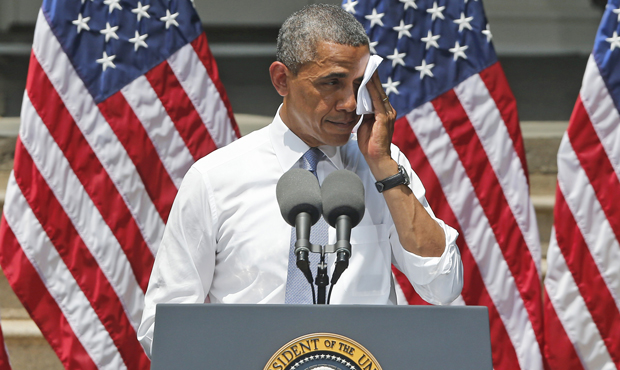 President Barack Obama wipes perspiration from his face as he speaks about climate change and his Climate Action Plan on June 25, 2013, in Washington, D.C. (AP/Charles Dharapak)