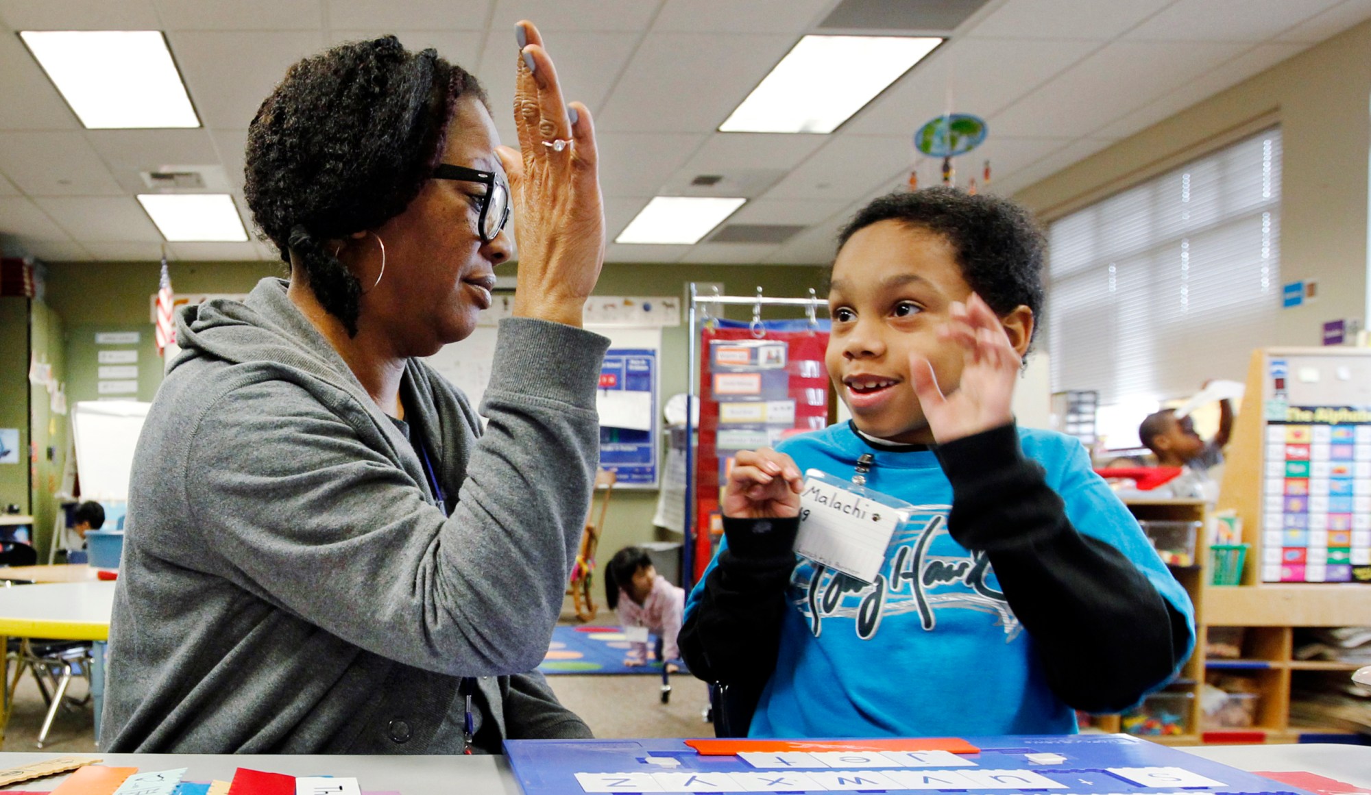 Malachi Stewart works with educational assistant Addison Hawk at Campbell Hill Elementary in Renton, Washington. (AP/Elaine Thompson)