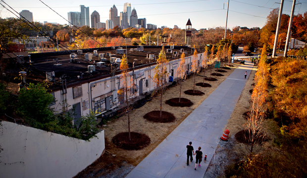 A couple walks along the Atlanta BeltLine as the midtown skyline stands in the background in Atlanta, November 20, 2012. (AP/David Goldman)