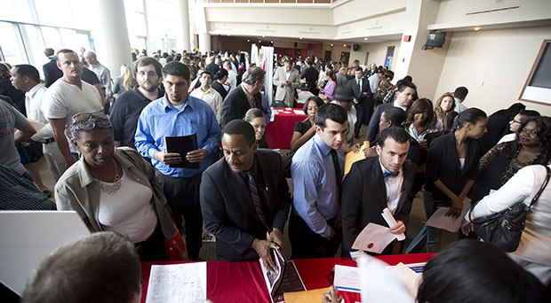 Job seekers fill a room at the job fair. In the State of the Union, President Barack Obama must address the minimum wage and retirement security, among other topics, to tackle inequality. (AP/J Pat Carter)