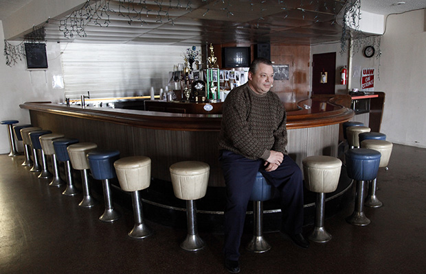 United Auto Workers Local 174 President John Zimmick sits at the bar at the union hall in Romulus, Michigan, March 22, 2013. (AP/Paul Sancya)