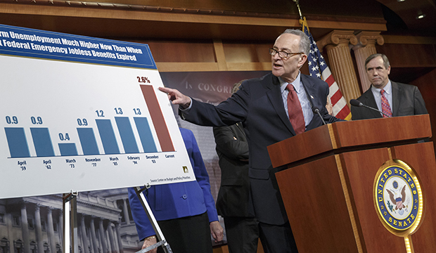 Sen. Charles Schumer (D-NY), left, accompanied by Sen. Jeff Merkley (D-OR), meets with reporters on Capitol Hill in Washington, Tuesday, January 7, 2014. (AP/J. Scott Applewhite)